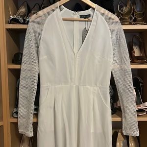 White jumpsuit with fishnet mesh sleeves,includes pocketsNever worn tag attached